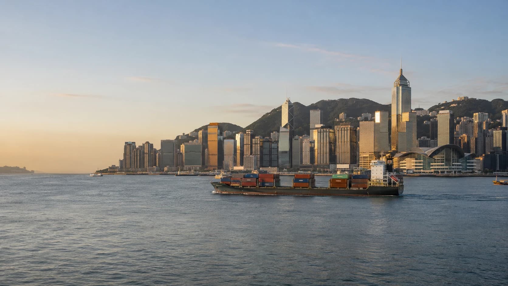 Hong Kong skyline across Victoria Harbour at golden hour — Essencia Trade's international trading hub